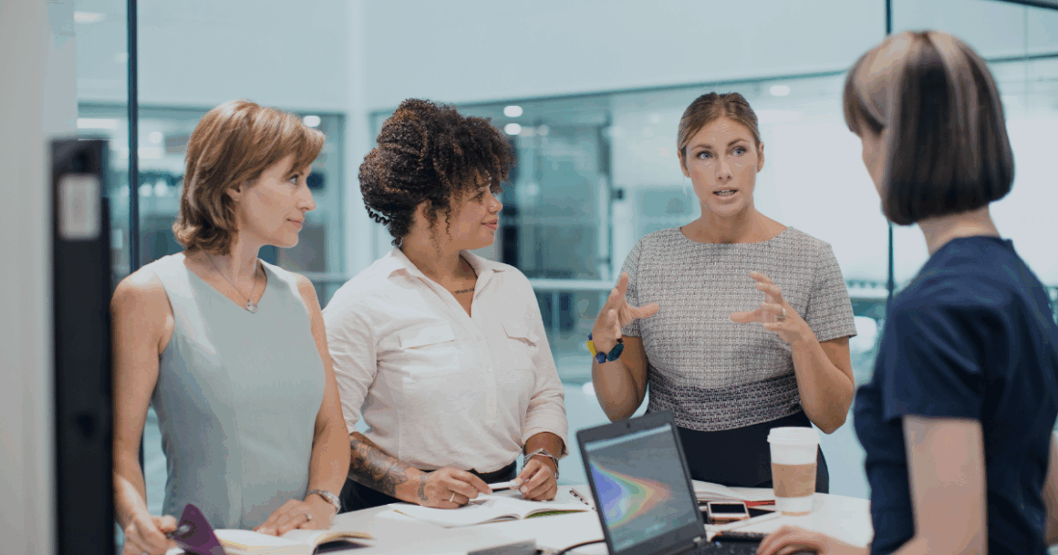 Engineers discussing SimPowerSystems simulation workflows in an office meeting.