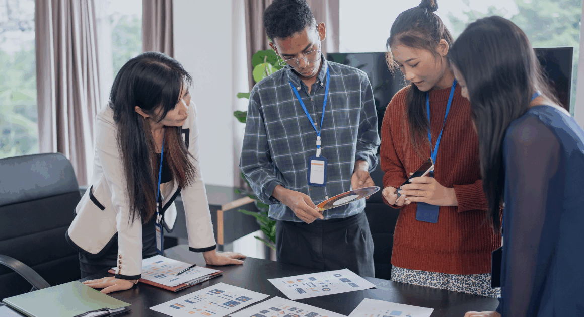 Engineers reviewing performance data on a chart during a team discussion.